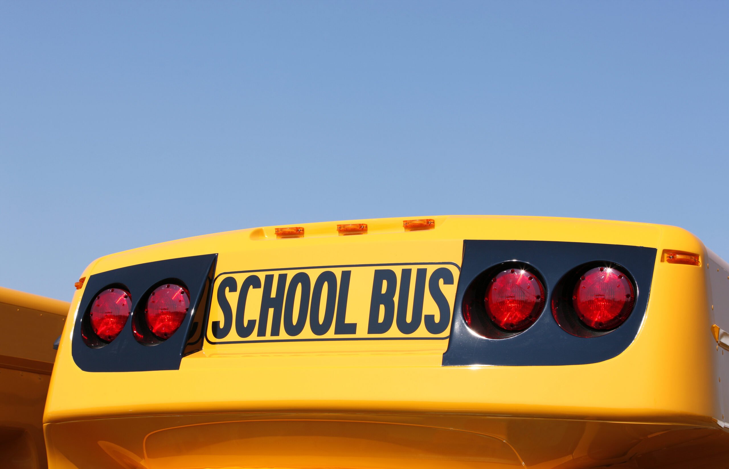 Close-up of a "SCHOOL BUS" sign, signifying how a PTO organization can support education in your community.